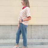 Bright floral v-neck top with dolman sleeves and drop shoulder design, styled for a relaxed and feminine look.