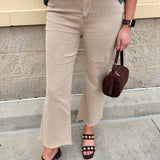 Light brown ash mocha high-waisted bootcut jeans with frayed hem styled for fall.