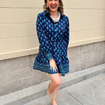 Blue floral print mini shirt dress with long sleeves, button cuffs, and removable belt