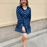 Blue floral print mini shirt dress with long sleeves, button cuffs, and removable belt