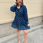 Blue floral print mini shirt dress with long sleeves, button cuffs, and removable belt