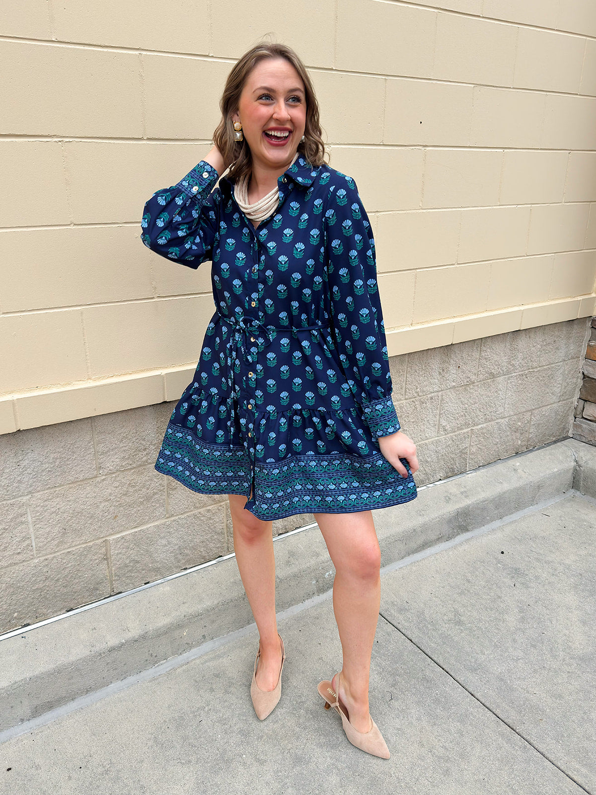 Blue floral print mini shirt dress with long sleeves, button cuffs, and removable belt