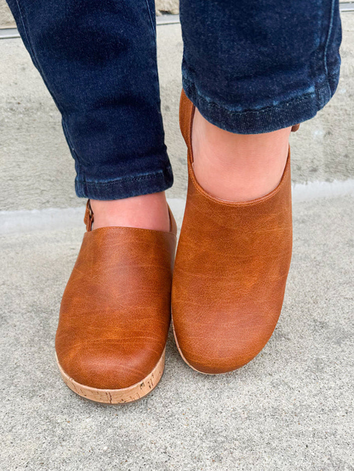 Corky’s Low Temps Rust Clogs with cork wedge, vegan leather upper, closed toe, and ankle strap.