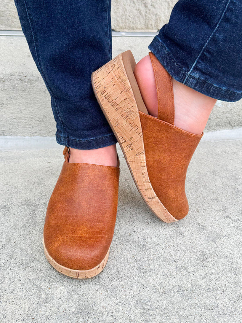 Corky’s Low Temps Rust Clogs with cork wedge, vegan leather upper, closed toe, and ankle strap.
