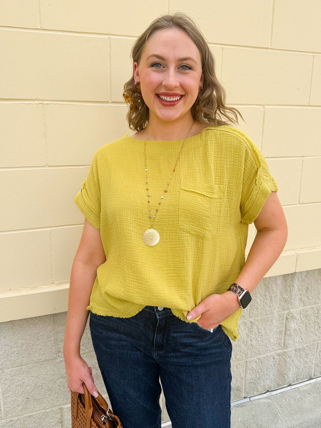 Mustard oversized ribbed top with front pocket, drop shoulders, and raw frayed hemline