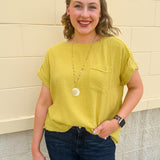 Mustard oversized ribbed top with front pocket, drop shoulders, and raw frayed hemline