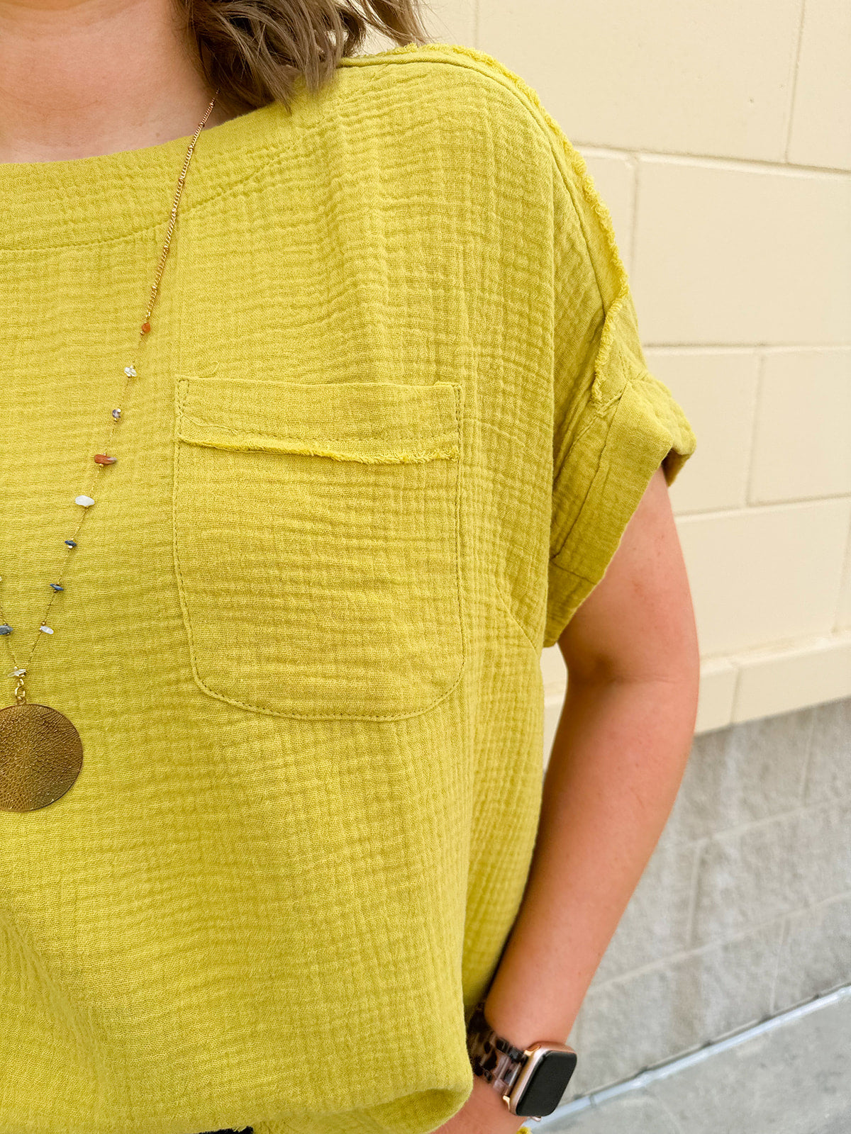 Mustard oversized ribbed top with front pocket, drop shoulders, and raw frayed hemline