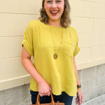 Mustard oversized ribbed top with front pocket, drop shoulders, and raw frayed hemline