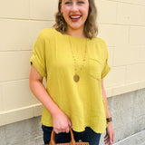 Mustard oversized ribbed top with front pocket, drop shoulders, and raw frayed hemline