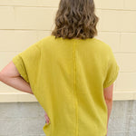 Mustard oversized ribbed top with front pocket, drop shoulders, and raw frayed hemline