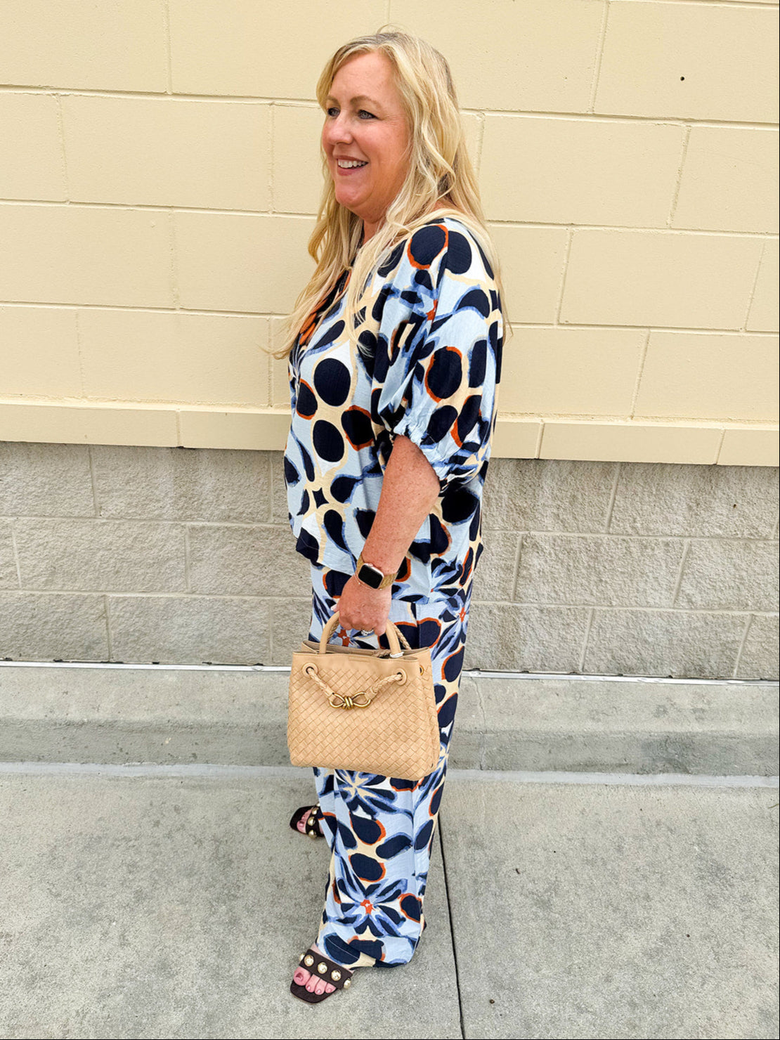 Printed short sleeve top in light blue with colorful indigo, orange, and yellow pattern, featuring a boat neck and relaxed A-line shape