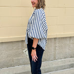 Lightweight striped button-down top in midnight blue and cream with ¾ pirate sleeves, styled for a casual coastal look