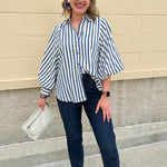 Lightweight striped button-down top in midnight blue and cream with ¾ pirate sleeves, styled for a casual coastal look