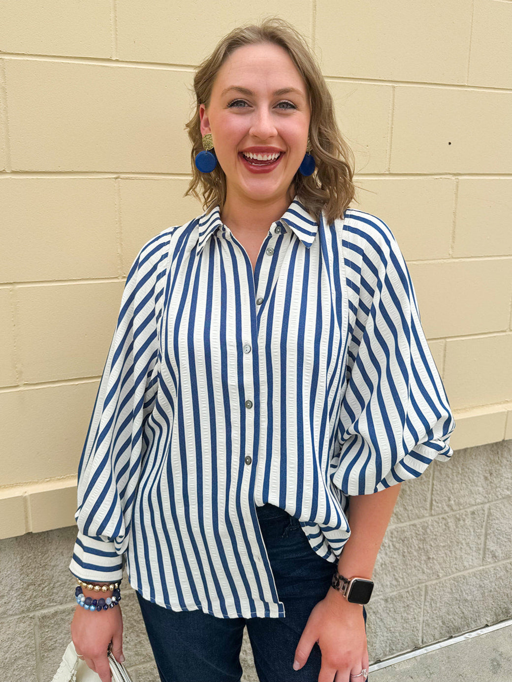 Lightweight striped button-down top in midnight blue and cream with ¾ pirate sleeves, styled for a casual coastal look