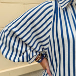 Lightweight striped button-down top in midnight blue and cream with ¾ pirate sleeves, styled for a casual coastal look