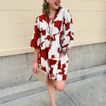 Rust and cream tie-neck mini dress with voluminous sleeves and banded cuffs