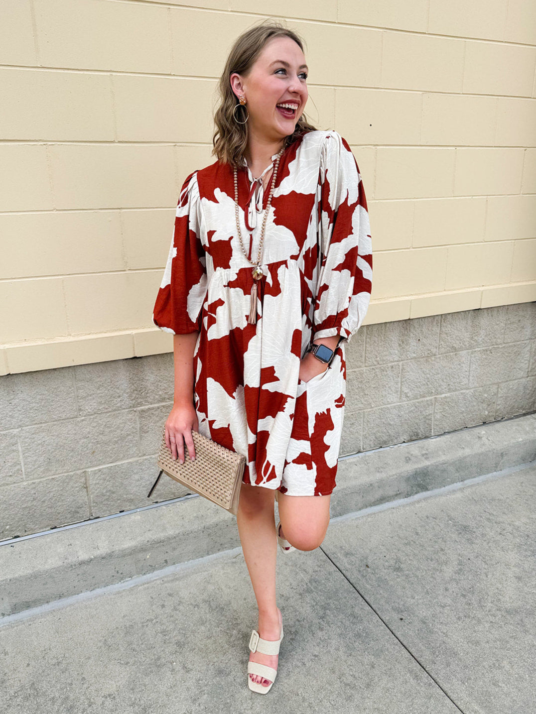 Rust and cream tie-neck mini dress with voluminous sleeves and banded cuffs