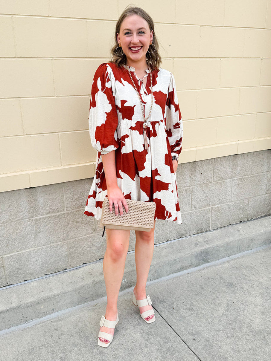 Rust and cream tie-neck mini dress with voluminous sleeves and banded cuffs