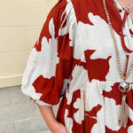 Rust and cream tie-neck mini dress with voluminous sleeves and banded cuffs