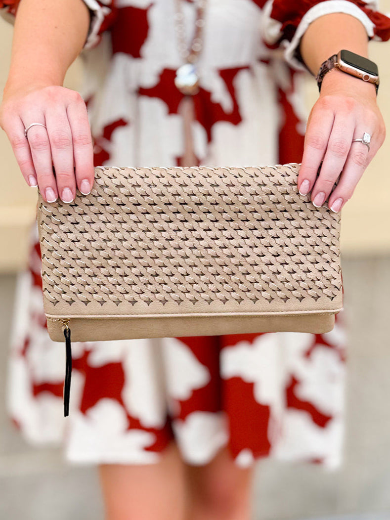 Light tan woven clutch with black and tan tassel zipper pull