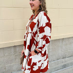 Rust and cream tie-neck mini dress with voluminous sleeves and banded cuffs