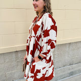 Rust and cream tie-neck mini dress with voluminous sleeves and banded cuffs