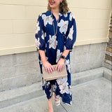 Navy midi dress with white floral details, collar, and 3/4-length sleeves