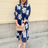 Navy midi dress with white floral details, collar, and 3/4-length sleeves