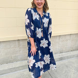 Navy midi dress with white floral details, collar, and 3/4-length sleeves