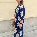 Navy midi dress with white floral details, collar, and 3/4-length sleeves