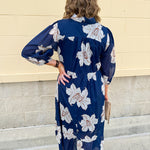 Navy midi dress with white floral details, collar, and 3/4-length sleeves
