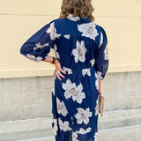 Navy midi dress with white floral details, collar, and 3/4-length sleeves