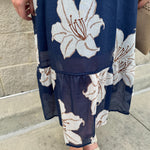Navy midi dress with white floral details, collar, and 3/4-length sleeves