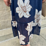 Navy midi dress with white floral details, collar, and 3/4-length sleeves