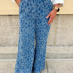 Medium wash wide-leg denim palazzo pants with chenille flower embroidery