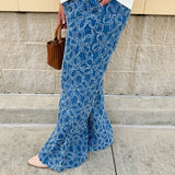 Medium wash wide-leg denim palazzo pants with chenille flower embroidery