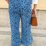 Medium wash wide-leg denim palazzo pants with chenille flower embroidery