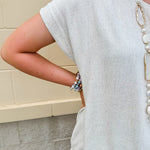 Linen-cotton blend short-sleeve top with front tie and raw hem in a soft neutral oatmeal shade.