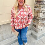 Cream shirt with rust pattern, collar, one button, and ¾-length cuffed sleeves