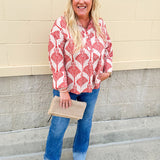 Cream shirt with rust pattern, collar, one button, and ¾-length cuffed sleeves