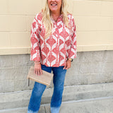 Cream shirt with rust pattern, collar, one button, and ¾-length cuffed sleeves