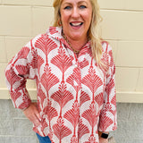 Cream shirt with rust pattern, collar, one button, and ¾-length cuffed sleeves