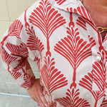 Cream shirt with rust pattern, collar, one button, and ¾-length cuffed sleeves