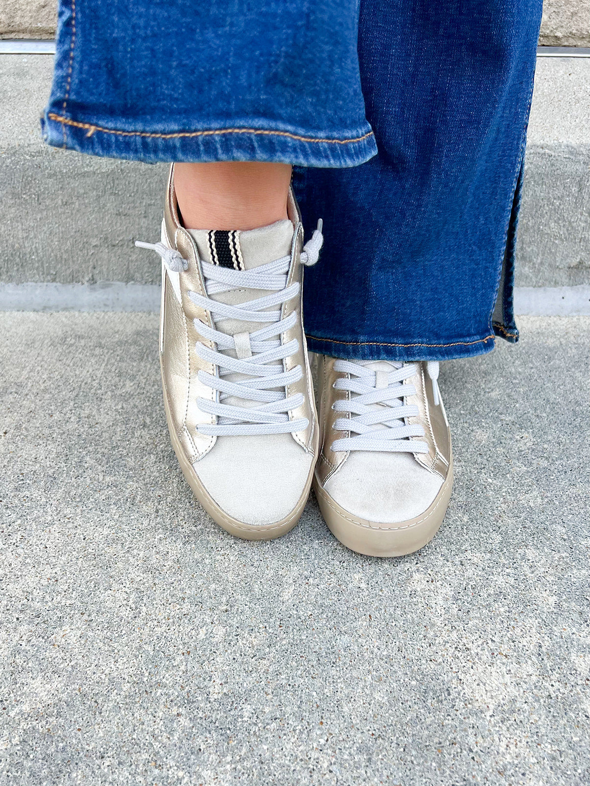 Cream textured sneakers with gold and white accents