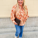 Floral paisley blouse with pleated bib front, balloon sleeves, and a soft standing collar styled for a vintage-inspired look