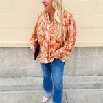 Floral paisley blouse with pleated bib front, balloon sleeves, and a soft standing collar styled for a vintage-inspired look