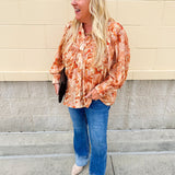 Floral paisley blouse with pleated bib front, balloon sleeves, and a soft standing collar styled for a vintage-inspired look