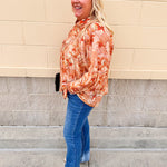 Floral paisley blouse with pleated bib front, balloon sleeves, and a soft standing collar styled for a vintage-inspired look