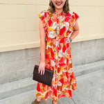 Collared midi dress with red, cream, and green pattern, ruffle sleeves, and buttons down front