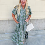 Green midi dress with white and pink floral print and short sleeves
